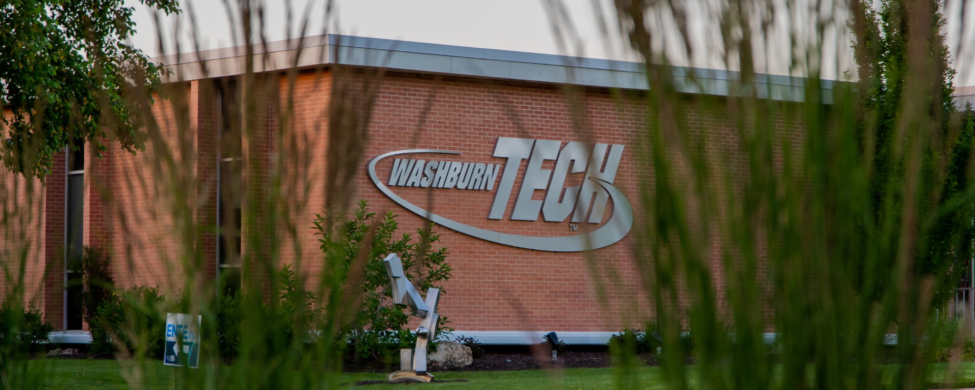 Washburn Tech exterior logo with grasses in foreground