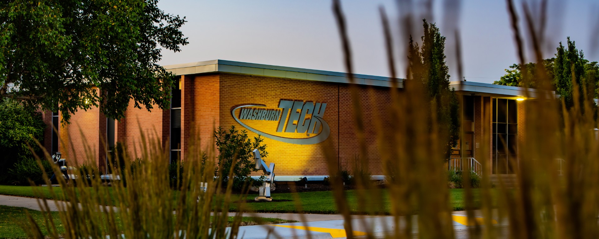 Washburn Teck sign on building at dusk