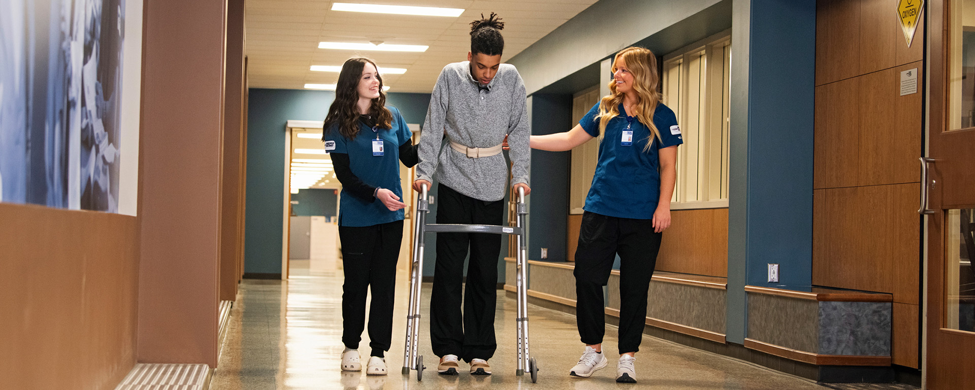 three students in healthcare hallway