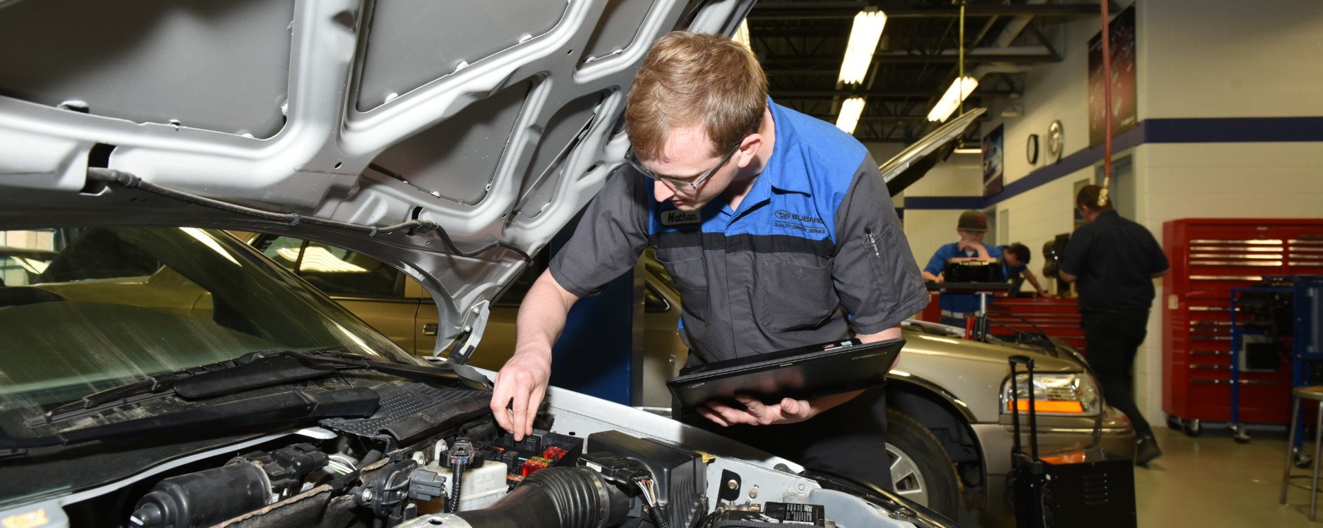 man working on car engine