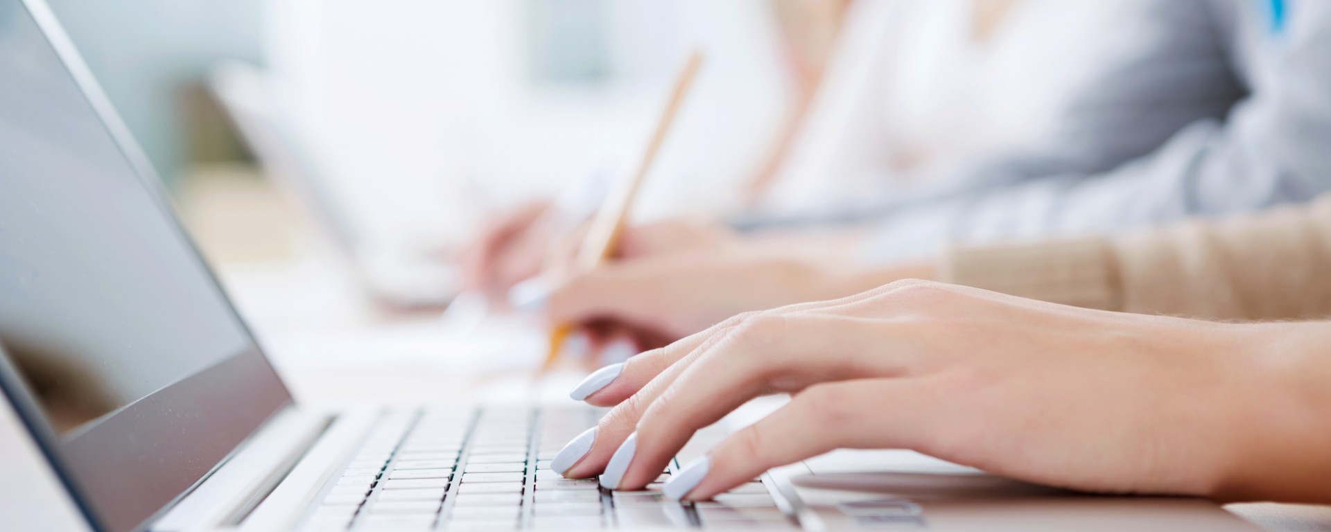 hands typing on a computer