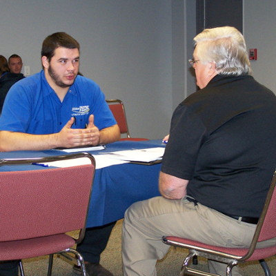 students talking to potential employers