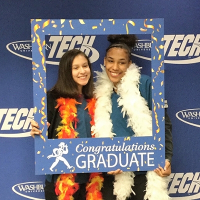two graduates celebrate their achievement