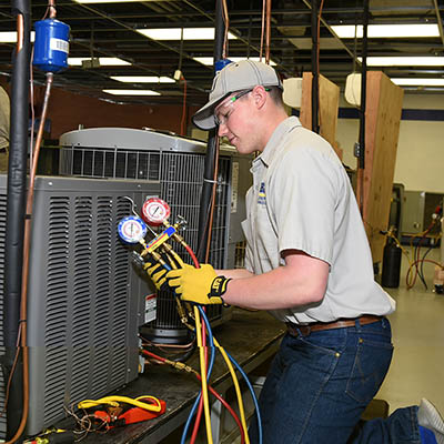 hvac student works on equipment