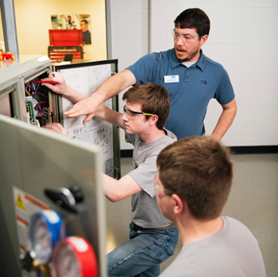 instructor with students in HVAC lab