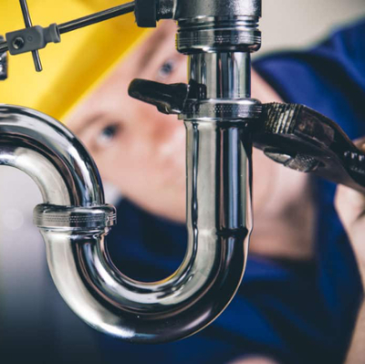 plumber working at a sink