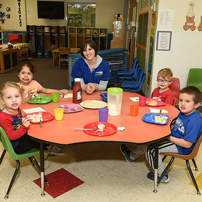 Little learners classroom with students and instructor at table