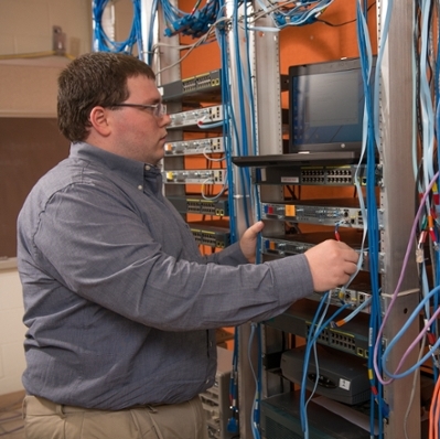 student with computer wiring