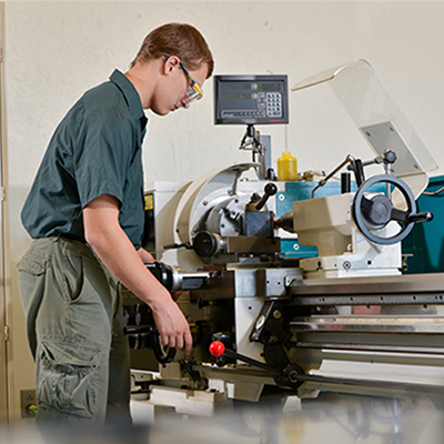 student using machining equipment