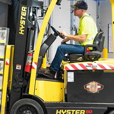 man driving forklift