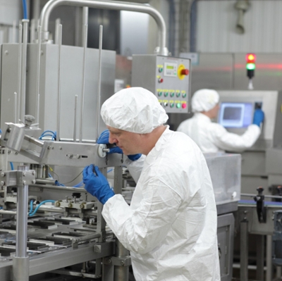 student in protective suit and head covering using equipment