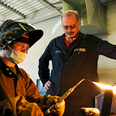 instructor with welding student